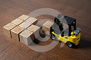 A forklift transports and places boxes. Order for shipment. Production and freight of goods. Increase in imports and exports. The photo