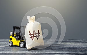 Forklift transports a south korean won money bag. Attraction of investments in business and economy, cheap loans, leasing