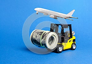 Forklift truck carries a bundle of dollars and airplane. Export of capital, offshore economic zones. Attracting direct investment