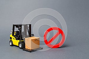 Forklift truck carries a cardboard box near a red symbol NO. Embargo, trade wars. No delivery. Restriction on the importation photo