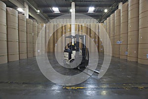 Forklift Truck And Huge Rolls Of Paper In Factory