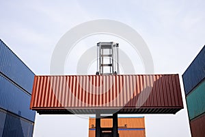 Forklift truck lifting cargo container clear sky background