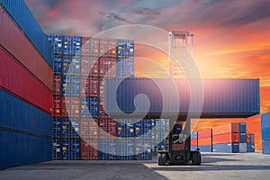 Forklift truck lifting cargo container in shipping yard or dock yard against sunrise sky for transportation import