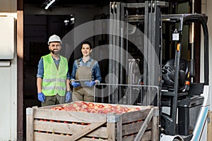 Forklift truck loading with full containers. Fruits and food distribution to market