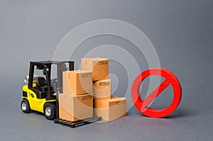 Forklift truck near cardboard boxes and a red symbol NO. Embargo, trade wars. Restriction on the importation of goods, proprietary photo