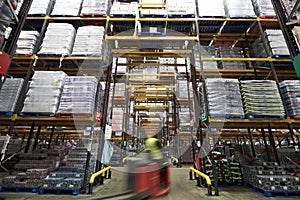 A forklift truck passing though a warehouse, motion blur