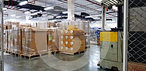 Forklift truck with a Safety Helmets Head Protection at large warehouse logistic or distribution center. Interior of warehouse