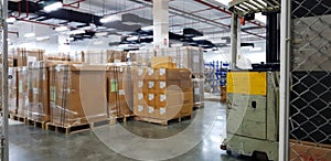 Forklift truck with a Safety Helmets Head Protectionin front of blurred large warehouse logistic or distribution center