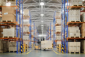 Forklift truck in warehouse or storage and shelves with cardboard boxes photo