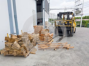 Forklift truck and  wooden pallets outside warehouse Soft focus