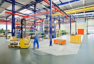 Forklift truck workers in a factory - manufacture of machinery a