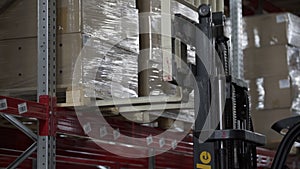 Forklift Trucks load Pallets with Cardboard Boxes at modern warehouse