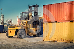 Forklift unloading and container stack in yard cargo shipping. , Heavy equipment.