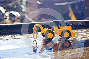 Forklift working on a road under an ice capped bridge. photo