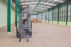 Forklifts inside empty warehouse with boxes background photo