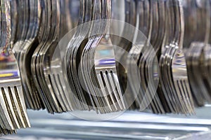 Forks and cutlery for sale in a hypermarket. Selective focus