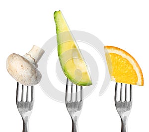 Forks with different vegetables and fruits on background. Healthy meal
