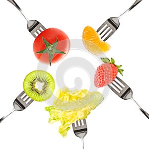 Forks with fruits and vegetables isolated on white