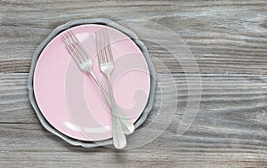 Forks on a pink plate