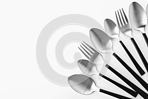 Forks and spoons on white background