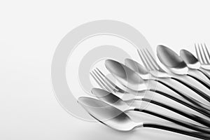 Forks and spoons on white background