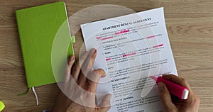 Form of lease agreement and tenant makes marks with pink marker