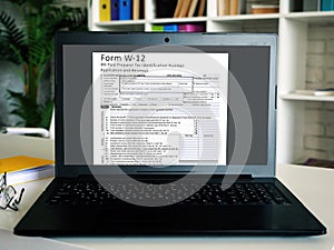 Form W-12 IRS Paid Preparer Tax Identification Number Application and Renewal  inscription on the piece of paper