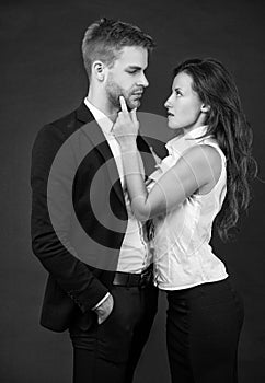 formal couple in love in business look on black background, businesspeople