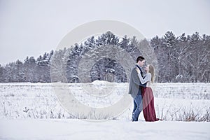 Formal couple outdoors in winter snow