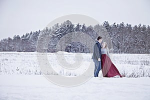 Formal couple outdoors in winter snow