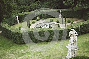 Formal English Garden with Pond and Antique Statues.