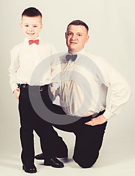 Formal event. Little son following fathers example of noble man. Gentleman upbringing. Father and son formal clothes