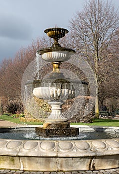 Formal flower gardens in Regent's Park, London UK, photographed in springtime with water fountain in foreground.
