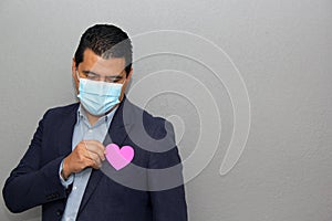 Formal latin man with blue jacket and red heart in his pocket. Valentine`s Day