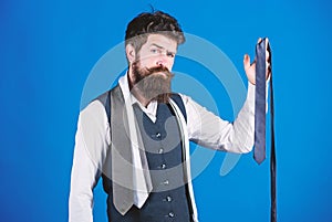 For formal occasions choose solid colored tie that is darker than your shirt. Match colors. Man bearded hipster hold few