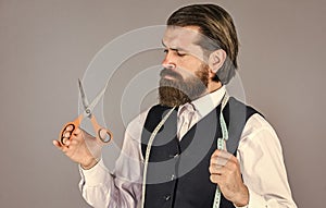 Formal and office style. man tailor with tape measure and scissors. man tailoring clothes. brutal man is fashion