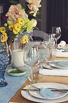 Formal table setting for lunch or dinner with flowers centrepiece photo