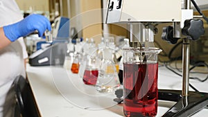 Formalin production testing. liquids being mixed in transparent bowl. Pharmacology specialist at work. Quality control