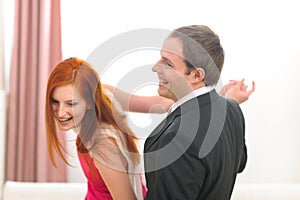 Formally dressed young couple having fun dancing photo