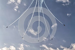 Formation of five airplanes in the sky at an air show