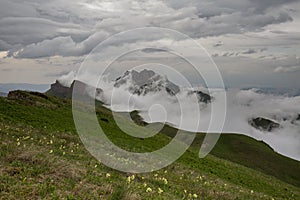 The formation and movements of clouds up to the steep slopes of the mountains of Central Caucasus peaks.