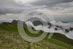 The formation and movements of clouds up to the steep slopes of the mountains of Central Caucasus peaks.