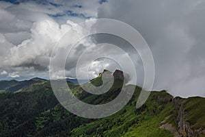 The formation and movements of clouds up to the steep slopes of the mountains of Central Caucasus peaks.