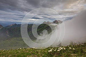 The formation and movements of clouds up to the steep slopes of the mountains of Central Caucasus peaks.