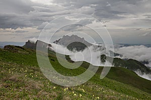 The formation and movements of clouds up to the steep slopes of the mountains of Central Caucasus peaks.