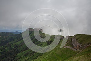 The formation and movements of clouds up to the steep slopes of the mountains of Central Caucasus peaks.