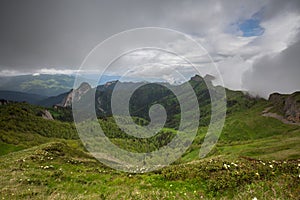 The formation and movements of clouds up to the steep slopes of the mountains of Central Caucasus peaks.