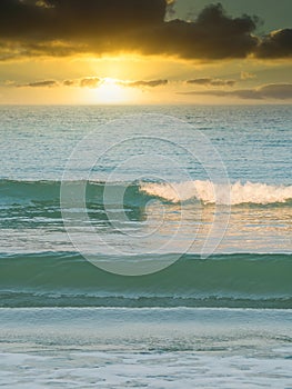 Formation of sea or ocean waves at sunset or sunrise. Beach summer landscape