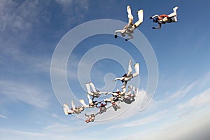 Formation skydiving in the blue sky.