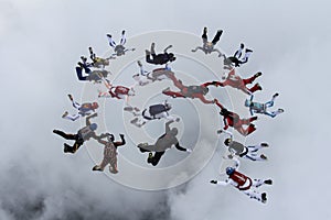 Formation skydiving in the cloudy sky.